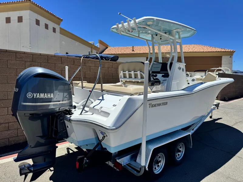 Slide: The Image of 2022 Tidewater 232 CC boat with Yamaha engine on trailer, parked outdoors. - 5