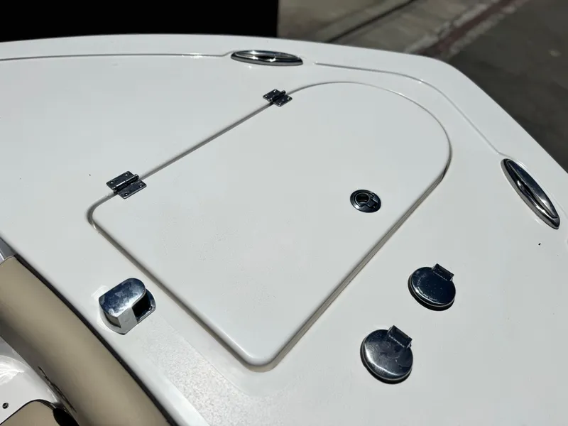Slide: The Image of 2022 Tidewater 232 CC boat deck with storage hatch and chrome fittings. - 9