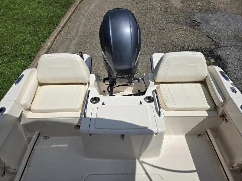 Slide: The Image of 2018 Grady-White Freedom 215 boat interior with seating and outboard motor. - 7