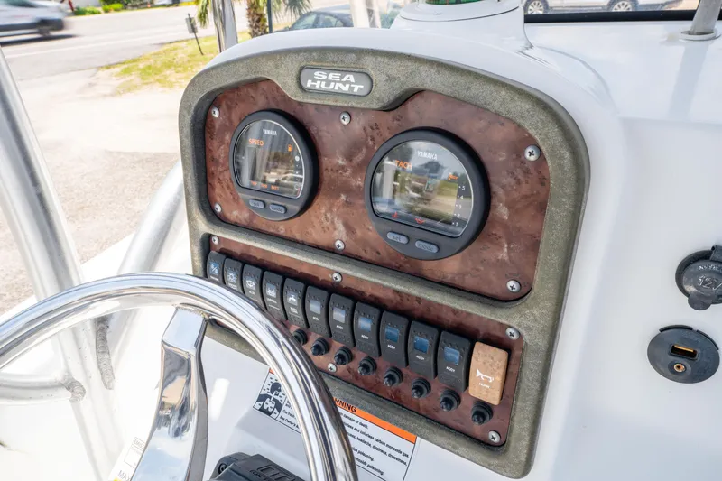 Slide: The Image of 2014 Sea Hunt 196 Ultra Center Console dashboard with gauges and controls. - 10
