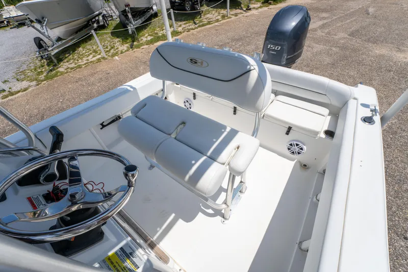 Slide: The Image of 2014 Sea Hunt 196 Ultra Center Console boat interior with steering wheel and seating. - 12