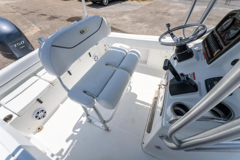 Slide: The Image of 2014 Sea Hunt 196 Ultra Center Console boat interior with steering wheel and seating. - 13