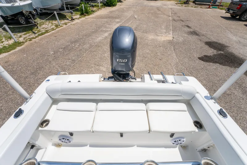 Slide: The Image of 2014 Sea Hunt 196 Ultra Center Console boat with Yamaha 150 engine, parked on pavement. - 17