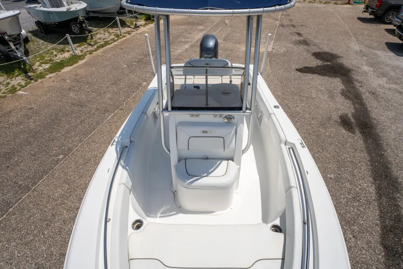 Slide: The Image of 2014 Sea Hunt 196 Ultra Center Console boat, white interior, parked on concrete surface. - 19