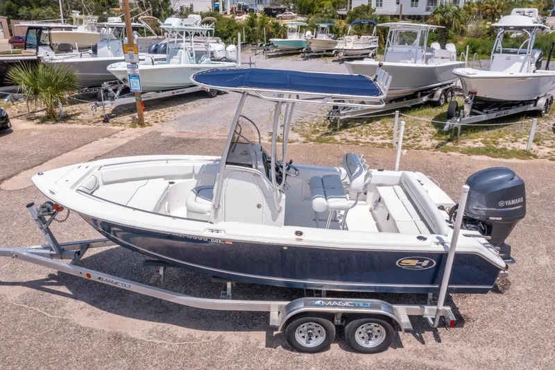 Slide: The Image of 2014 Sea Hunt 196 Ultra Center Console boat on trailer, featuring Yamaha outboard motor. - 2