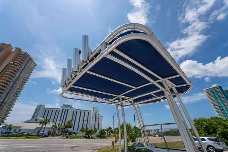 Slide: The Image of 2014 Sea Hunt 196 Ultra Center Console boat with T-top against urban skyline. - 21