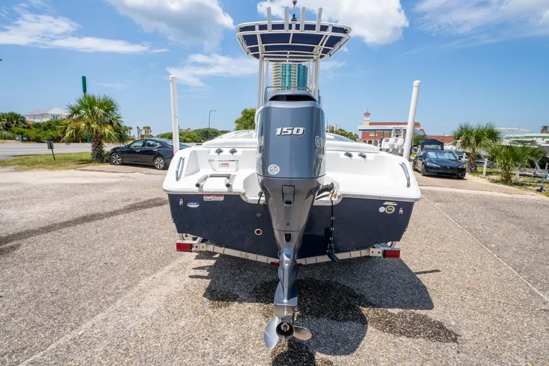 Slide: The Image of 2014 Sea Hunt 196 Ultra Center Console boat with Yamaha 150 engine, parked outdoors. - 8