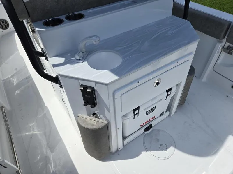 Slide: The Image of 2026 Sea Hunt Ultra 245SE boat interior with sink and Yamaha cooler. - 3
