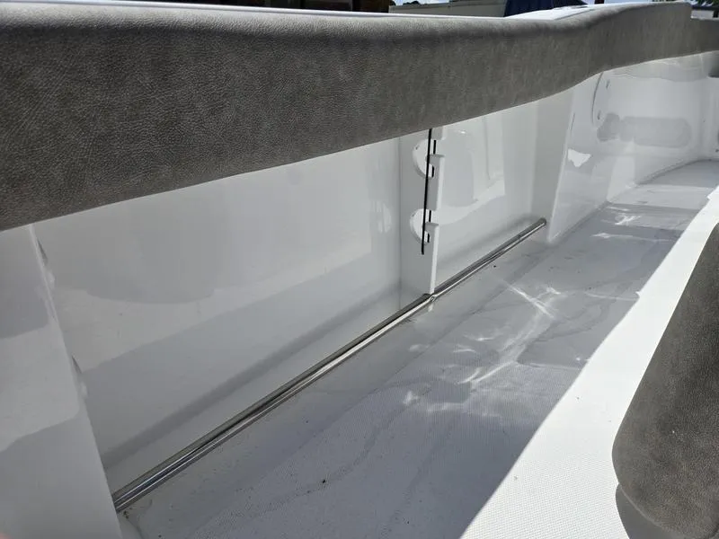 Slide: The Image of 2026 Sea Hunt Ultra 245SE boat interior with sleek, modern design and cushioned seating. - 5