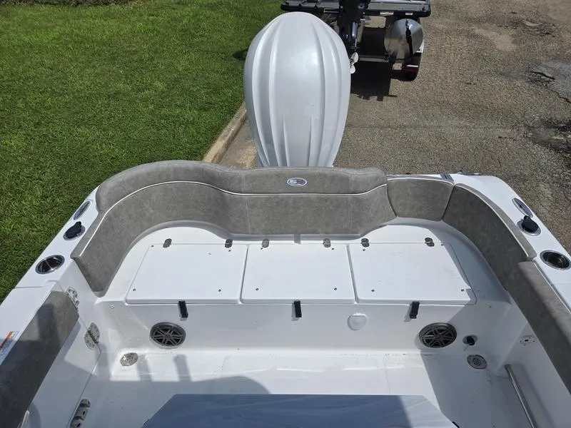 Slide: The Image of 2026 Sea Hunt Ultra 245SE boat interior with cushioned seating and storage compartments. - 6