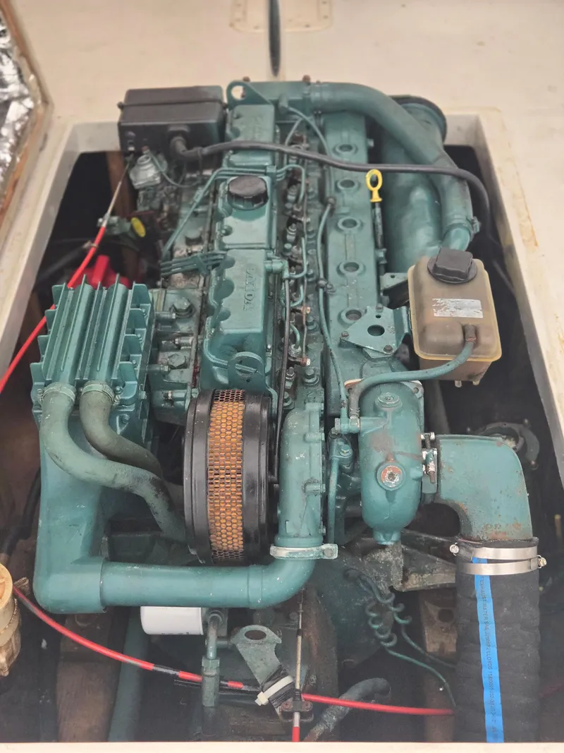 Slide: The Image of 1993 Fortier 26 engine compartment showcasing a well-maintained marine engine. - 16