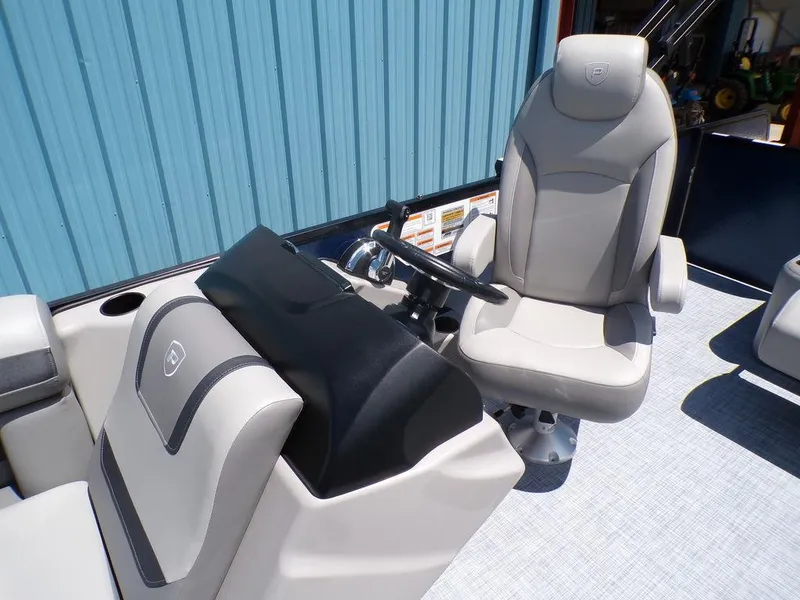 Slide: The Image of 2025 Premier 220 SUNSCAPE RL boat interior with captain's chair and steering console. - 10