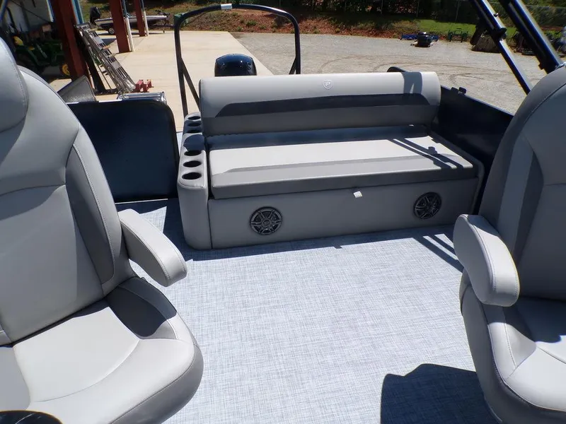 Slide: The Image of 2025 Premier 220 SUNSCAPE RL boat interior with gray seating and cup holders. - 13