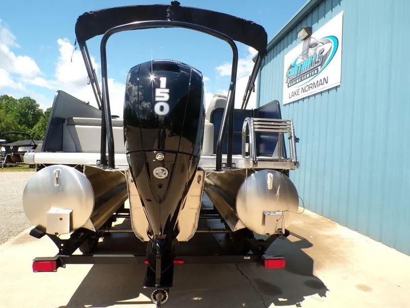 Slide: The Image of 2025 Premier 220 SUNSCAPE RL pontoon boat with 150 HP engine at dealership. - 6