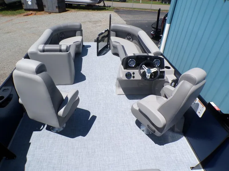 Slide: The Image of 2025 Premier 220 SUNSCAPE RL pontoon boat interior with gray seating and modern dashboard. - 9