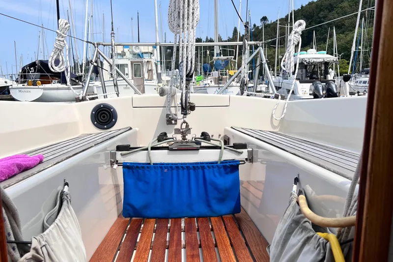Slide: The Image of Cockpit of 1978 Aphrodite 101 sailboat with wooden deck and marina view. - 7