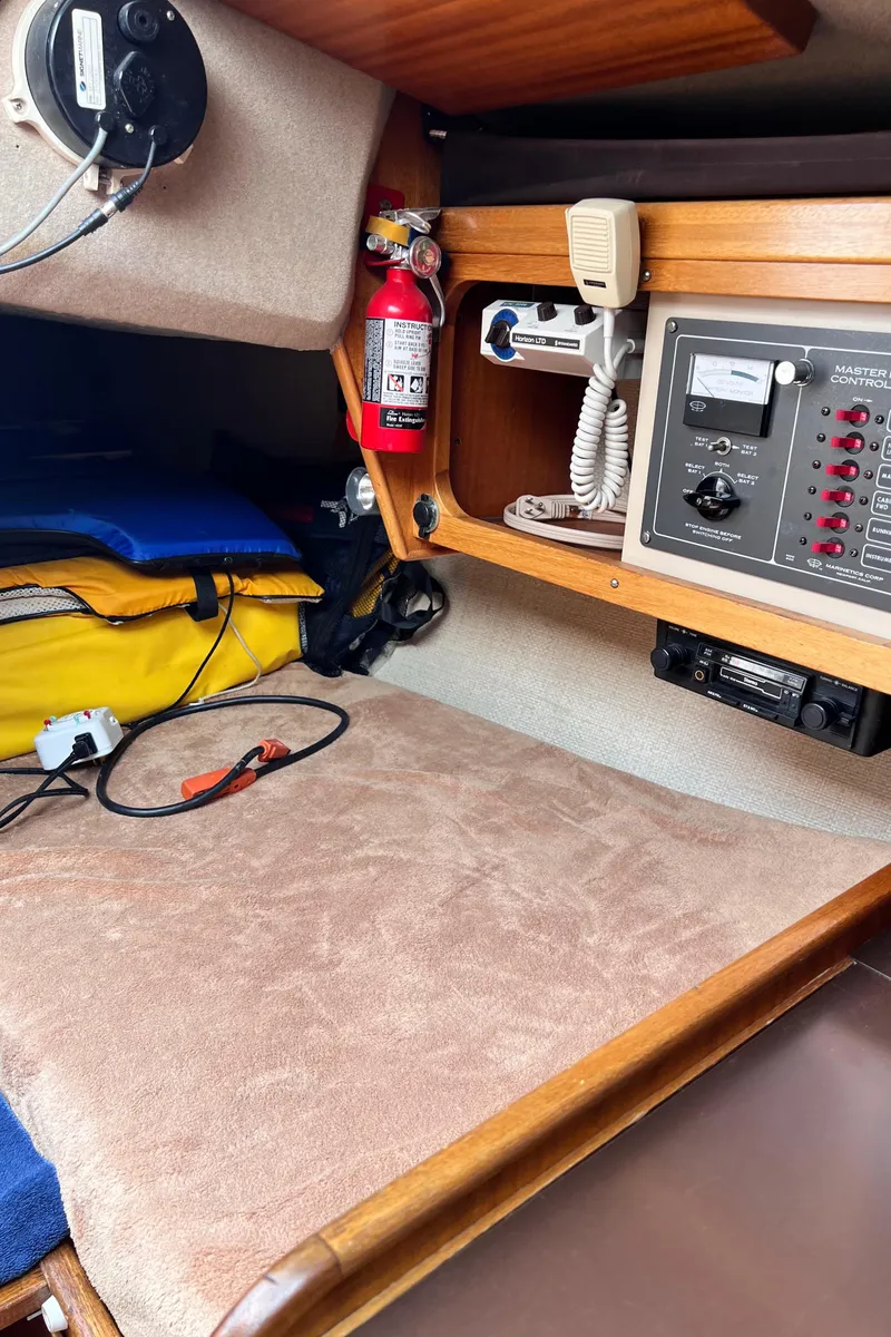 Slide: The Image of Interior of a 1978 Aphrodite 101 sailboat with navigation equipment and safety gear. - 8