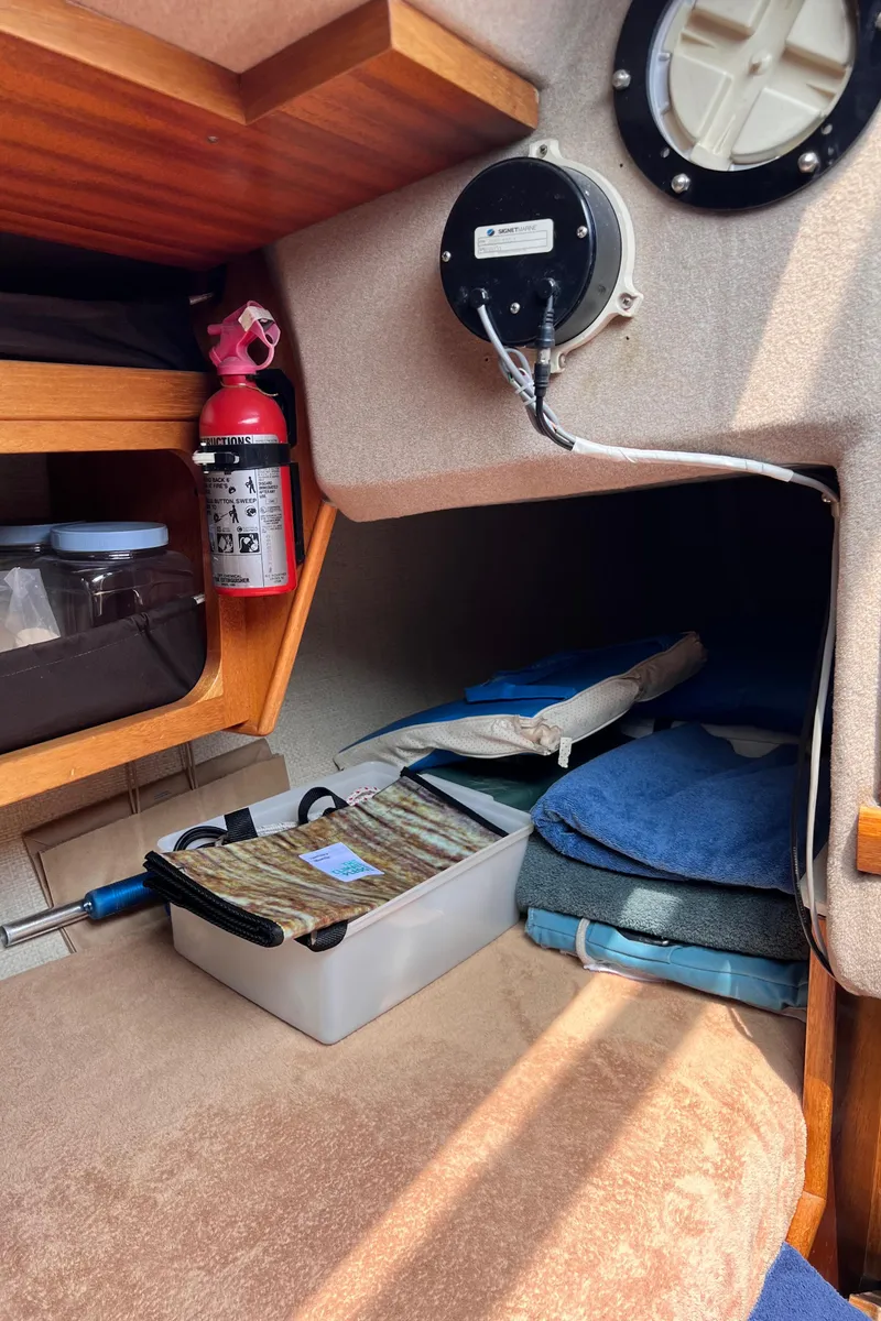 Slide: The Image of Cozy cabin interior of 1978 Aphrodite 101 sailboat with storage and safety equipment. - 9