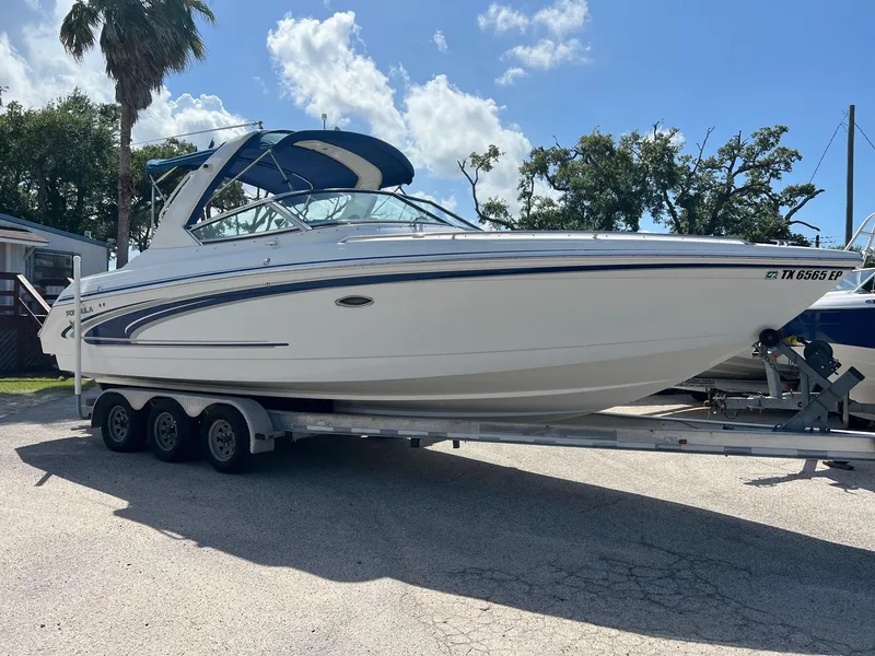 The Image of 2004 Formula 280 Bowrider boat on trailer under clear sky. - 1