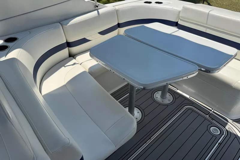 Slide: The Image of 2004 Formula 280 Bowrider interior with white seating and dual tables. - 18