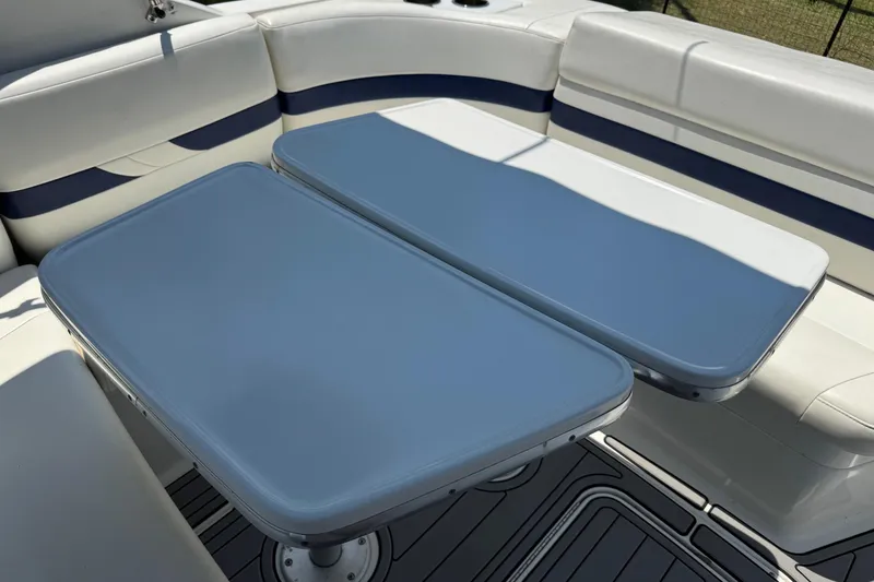 Slide: The Image of 2004 Formula 280 Bowrider interior with dual tables and cushioned seating. - 23