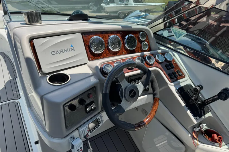 Slide: The Image of 2004 Formula 280 Bowrider dashboard with Garmin navigation and wood-accented steering wheel. - 24