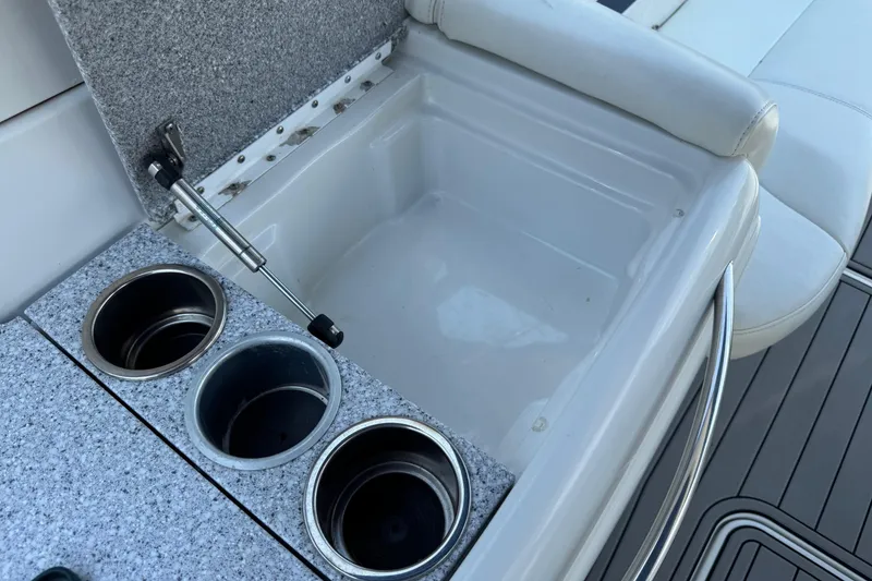Slide: The Image of 2004 Formula 280 Bowrider boat interior with cup holders and storage compartment. - 29