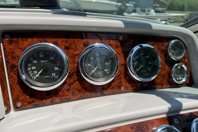 Slide: The Image of Dashboard of a 2004 Formula 280 Bowrider boat with wood paneling and gauges. - 31