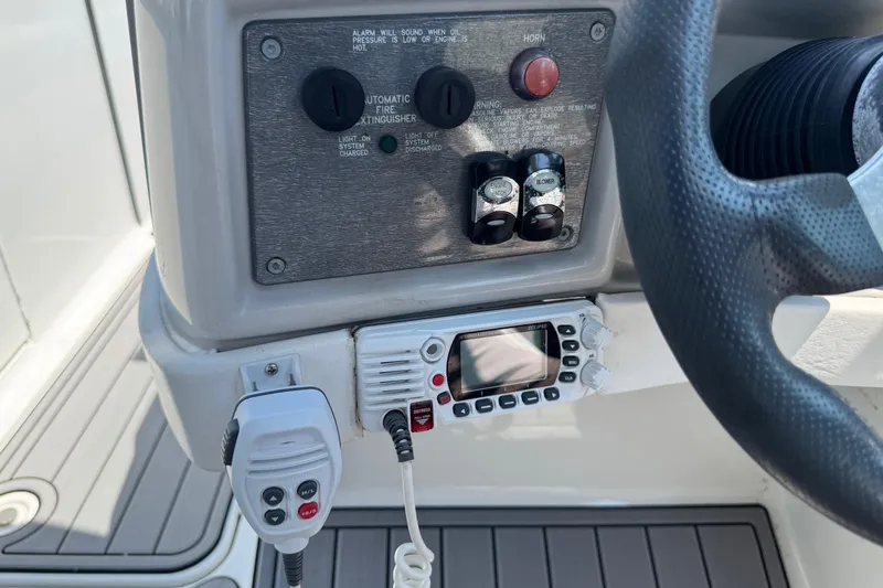 Slide: The Image of Control panel of a 2004 Formula 280 Bowrider boat with radio and switches. - 33