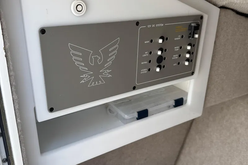 Slide: The Image of Control panel of a 2004 Formula 280 Bowrider boat, featuring various system switches. - 35