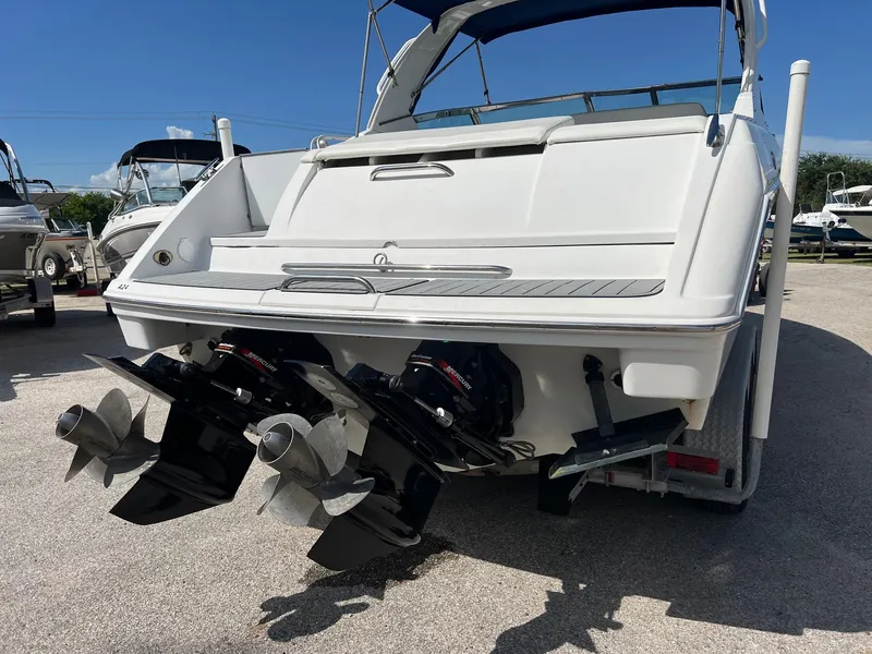 Slide: The Image of 2004 Formula 280 Bowrider boat with dual propellers, parked on a trailer. - 4