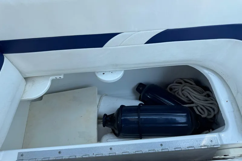 Slide: The Image of Storage compartment in a 2004 Formula 280 Bowrider with fenders and rope. - 50