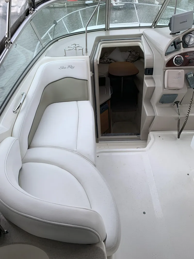Slide: The Image of 2006 Sea Ray 260 Sundancer interior with white seating and cabin entrance. - 4