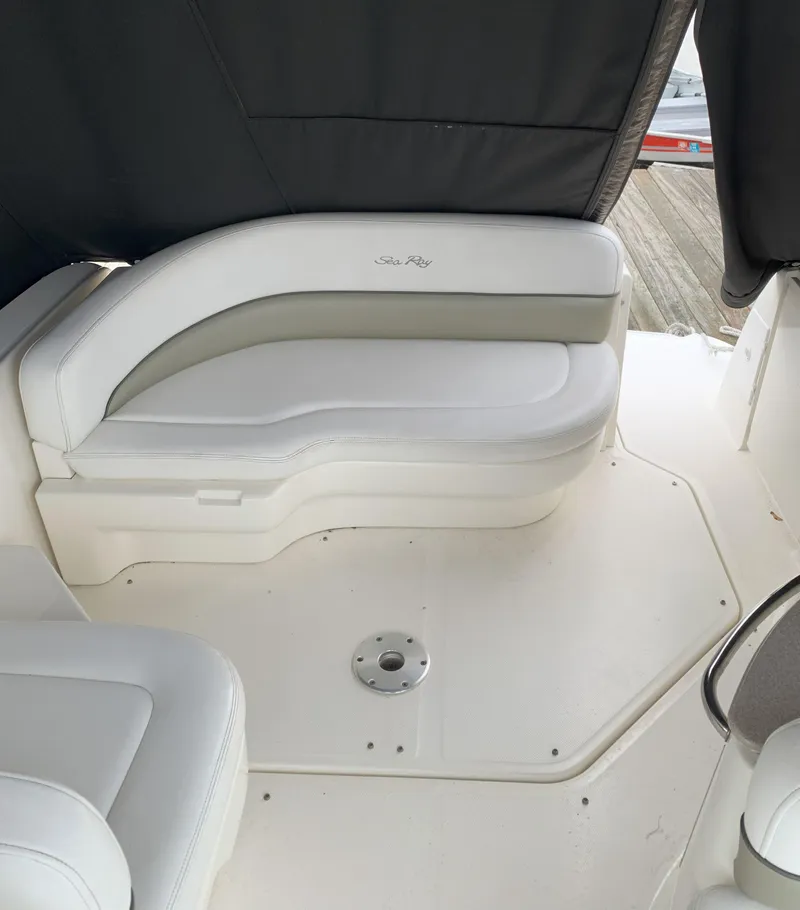 Slide: The Image of 2006 Sea Ray 260 Sundancer interior with white seating and black cover. - 5