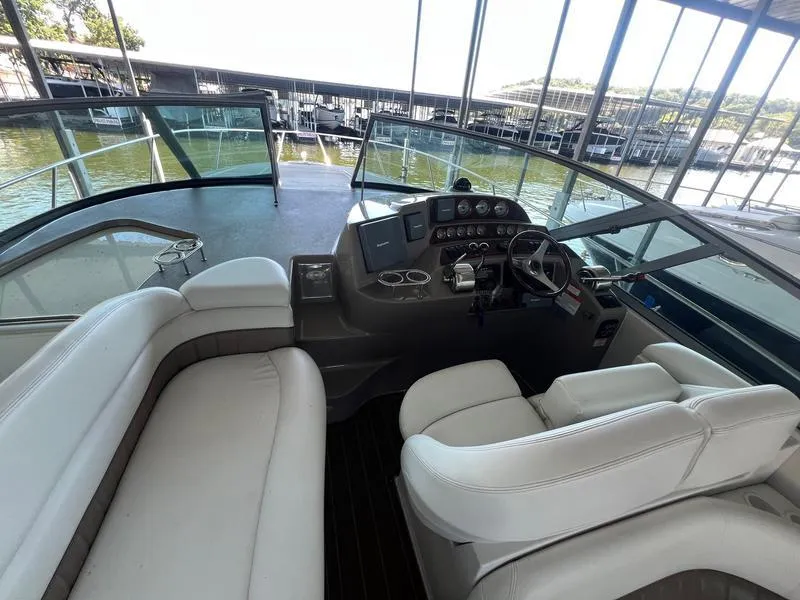 Slide: The Image of 2004 Four Winns 378 boat cockpit with white seating and control panel. - 10