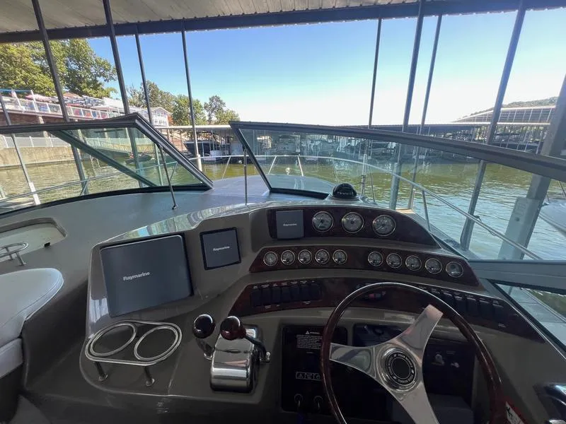 Slide: The Image of Helm of 2004 Four Winns 378 boat with navigation instruments and steering wheel. - 11