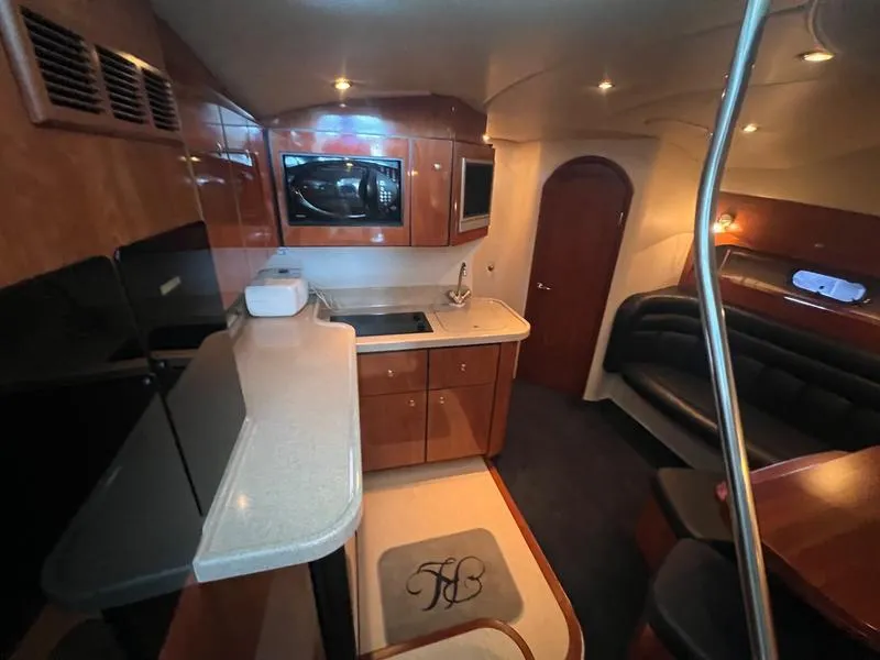 Slide: The Image of Luxurious 2004 Four Winns 378 yacht interior with kitchen and seating area. - 15