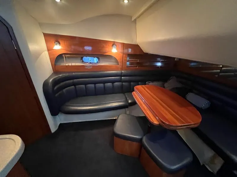 Slide: The Image of Interior of 2004 Four Winns 378 yacht with elegant seating and wooden table. - 18