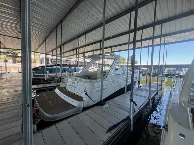 Slide: The Image of 2004 Four Winns 378 yacht docked in a covered marina slip. - 3