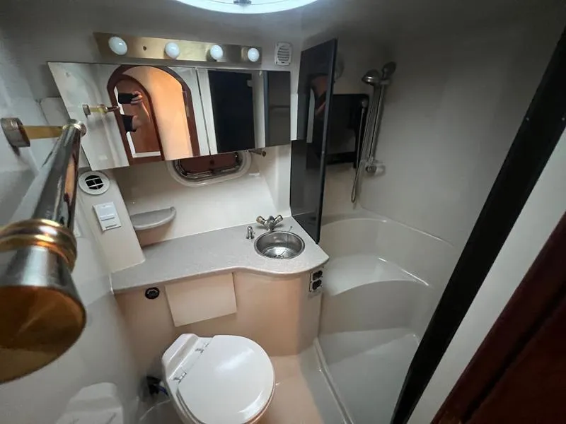 Slide: The Image of 2004 Four Winns 378 yacht bathroom with sink, toilet, and shower. - 6