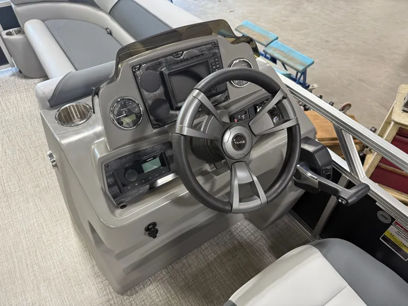 Slide: The Image of 2025 Tahoe Sport 2385 Swingback VRB boat console with steering wheel and controls. - 11