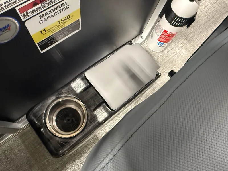 Slide: The Image of 2025 Tahoe Sport 2385 Swingback interior with cup holder and fire extinguisher. - 14