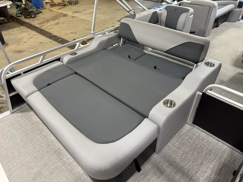 Slide: The Image of 2025 Tahoe Sport 2385 Swingback boat interior with gray seating and cup holders. - 17