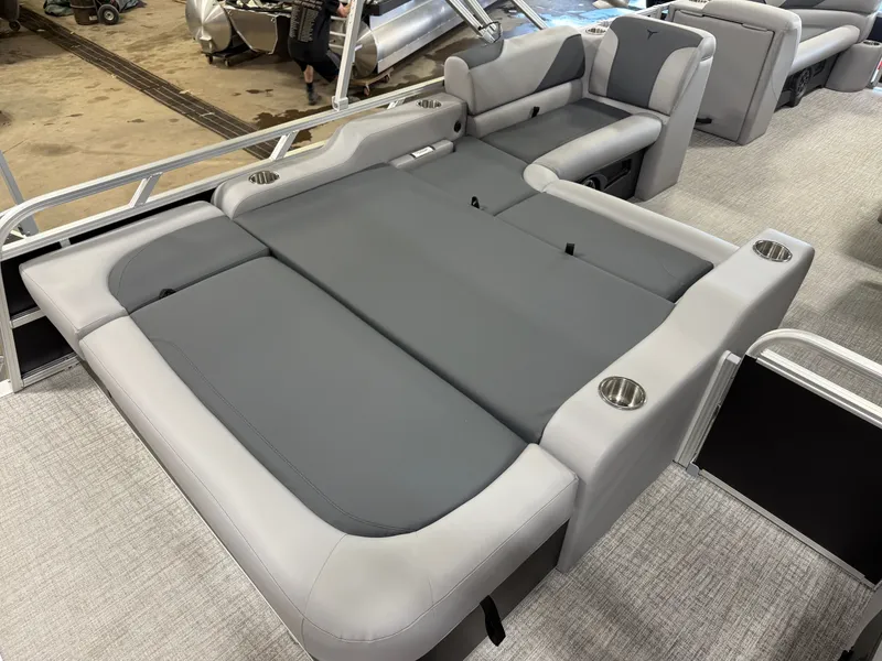 Slide: The Image of 2025 Tahoe Sport 2385 Swingback interior with gray seating and cup holders. - 19