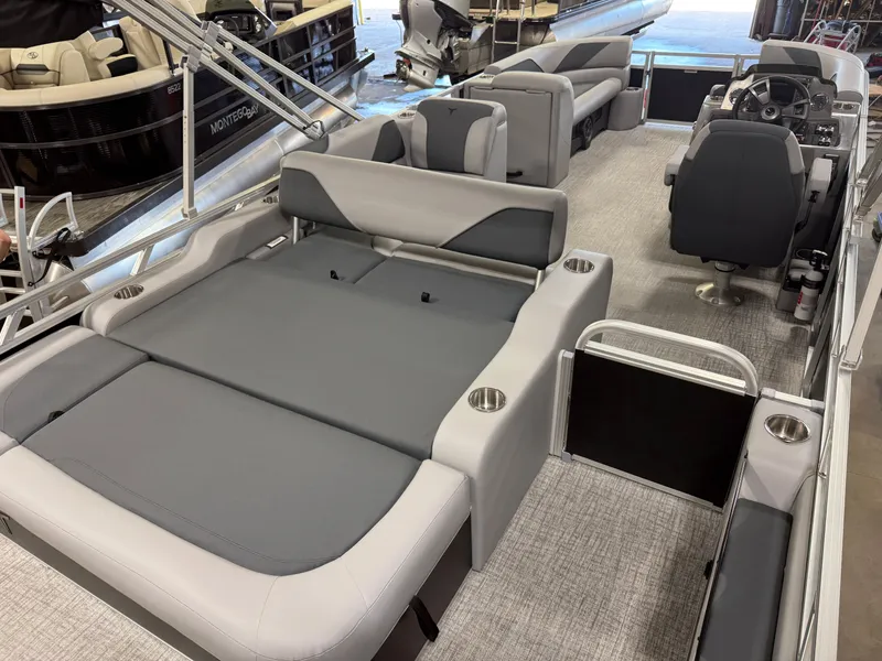 Slide: The Image of 2025 Tahoe Sport 2385 Swingback boat interior with modern seating and steering console. - 21