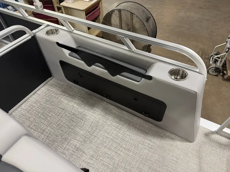 Slide: The Image of 2025 Tahoe Sport 2385 Swingback interior with cup holders and storage compartment. - 22