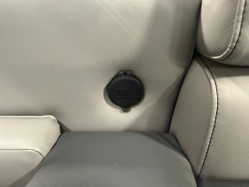 Slide: The Image of 2025 Tahoe Sport 2385 Swingback interior detail with power outlet on leather upholstery. - 23