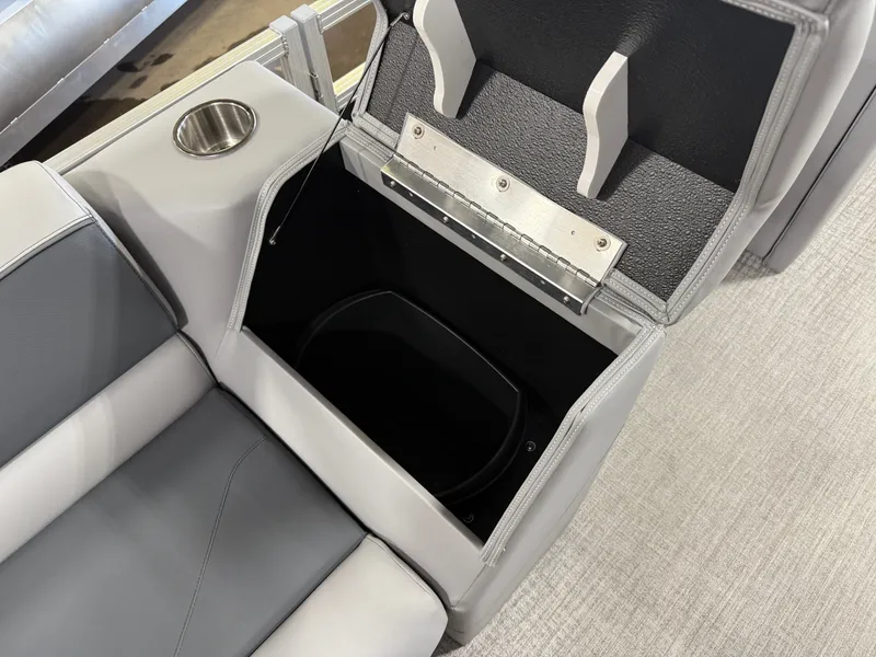 Slide: The Image of Open storage compartment in 2025 Tahoe Sport 2385 Swingback boat with cup holder. - 24