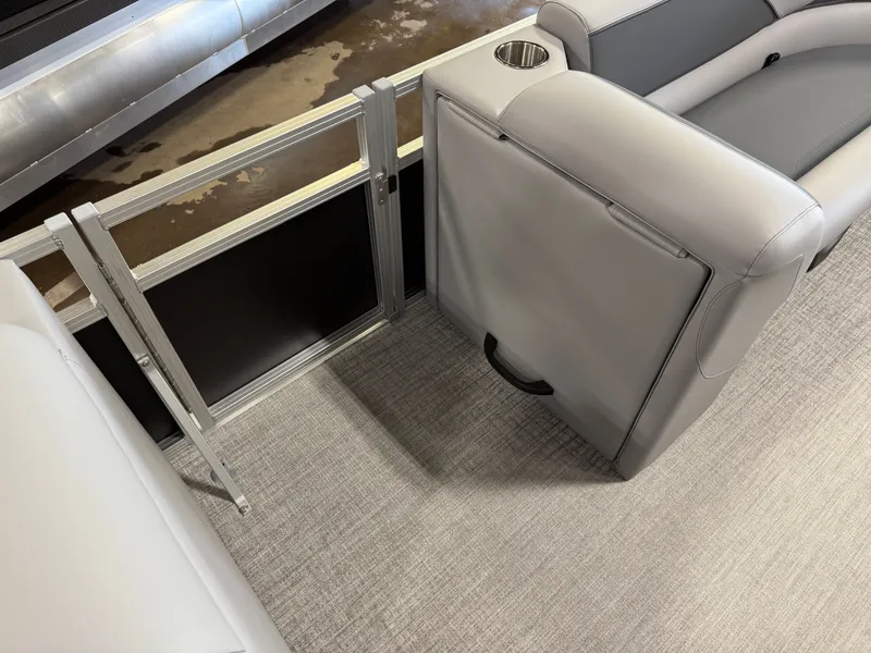 Slide: The Image of 2025 Tahoe Sport 2385 Swingback interior with gray seating and cup holder. - 25