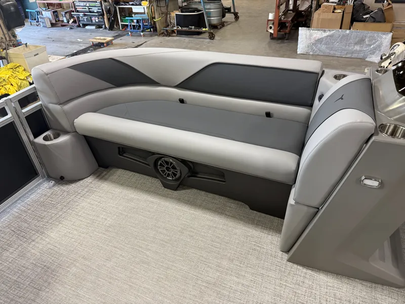 Slide: The Image of 2025 Tahoe Sport 2385 Swingback interior with gray seating and speaker system. - 28